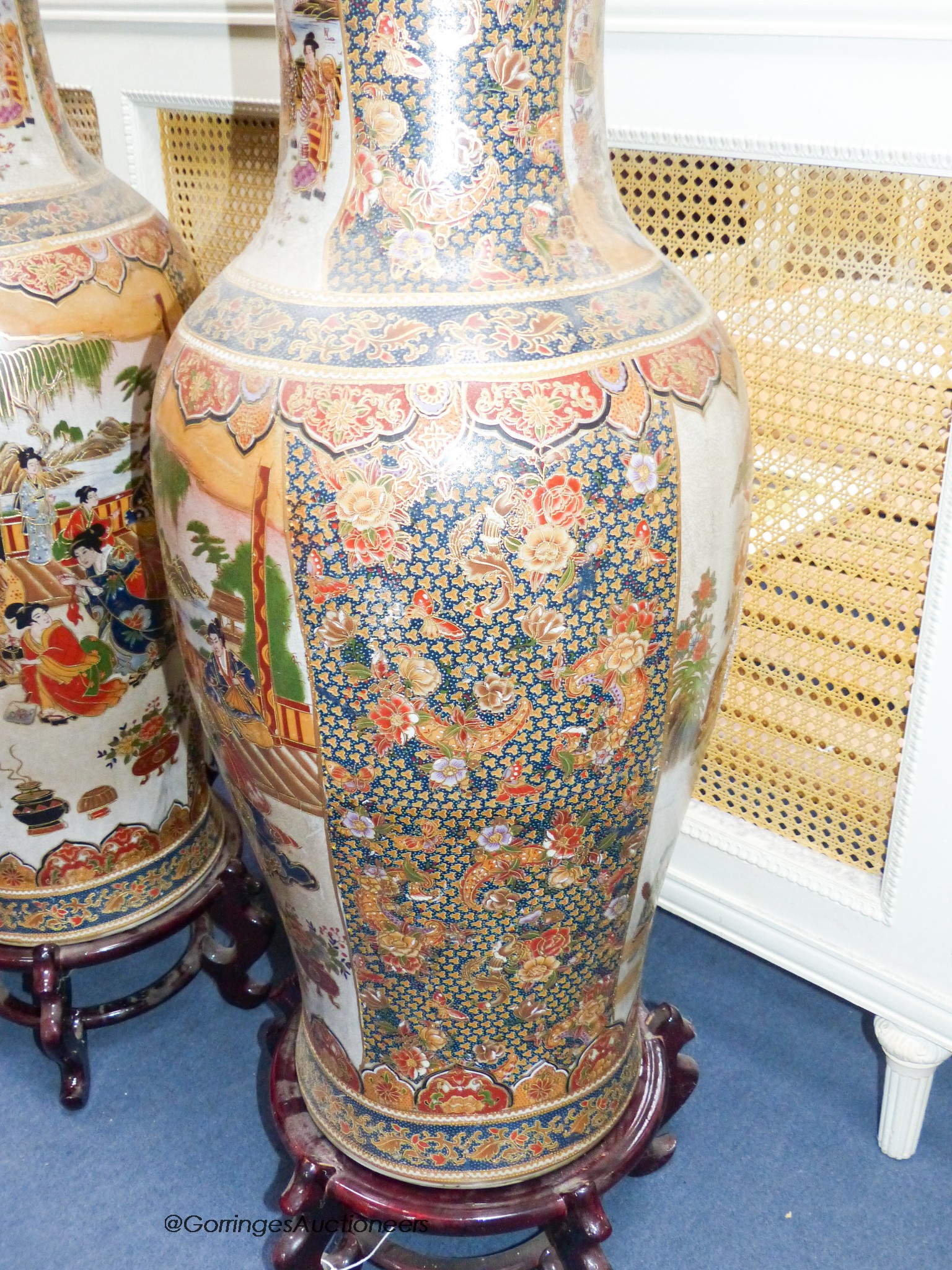 A pair of large Japanese vases, on hardwood stands